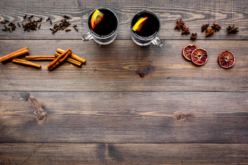 Ingredients for mulled wine. Spices cinnamon and badian, citrus fruits on dark wooden background top view copyspace