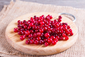 Fresh cranberry (cowberry) on wooden background