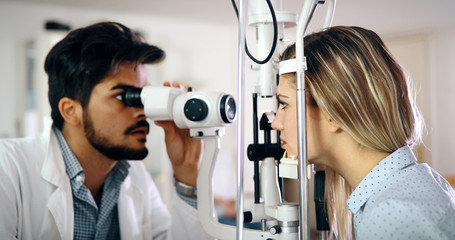 Optometrist examining patient in modern ophthalmology clinic