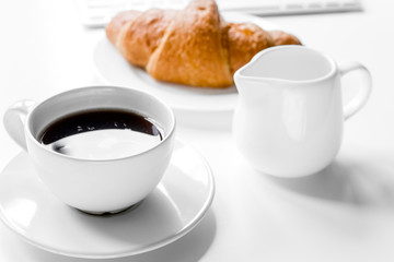 Business breakfast in office with milk, coffee and croissant on 
