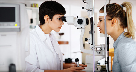 optometrist checking patient eyesight and vision correction