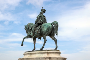 statue with blue sky at Piazza Venezia in rome