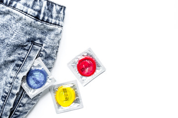 condoms and jeans for male contraception and birth control white
