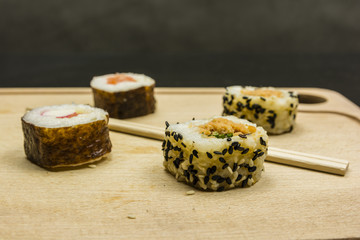 Futomaki and california roll (california maki) and chopsticks.