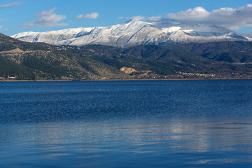 Fototapeta na wymiar Amazing panoramic Landscape of Lake Pamvotida, Pindus mountain and city of Ioannina, Epirus, Greece