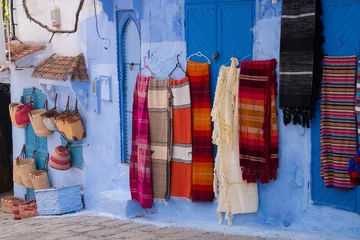 Traditional moroccan courtyard in Chefchaouen blue city medina in Morocco, architectural details in Blue town Chaouen. Typical blue walls and colorful flower pots. © sefoma