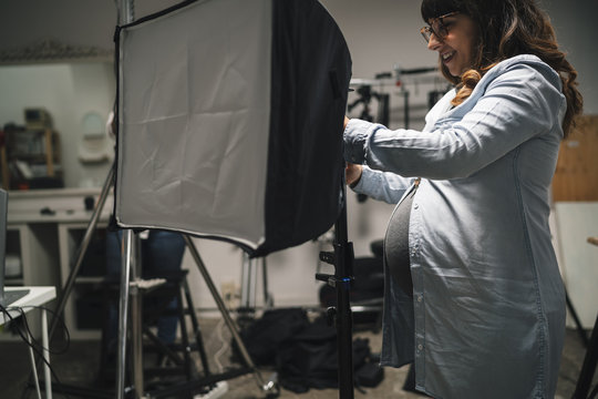 Pregnant woman working in a photographic studio