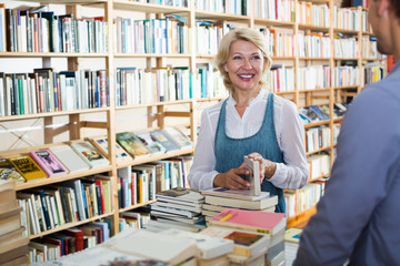 mature woman with assistant in book store.
