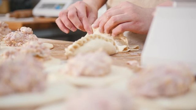 Cook is shaping bakery products by hands