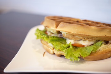 Waffles sandwich with ham cheese.