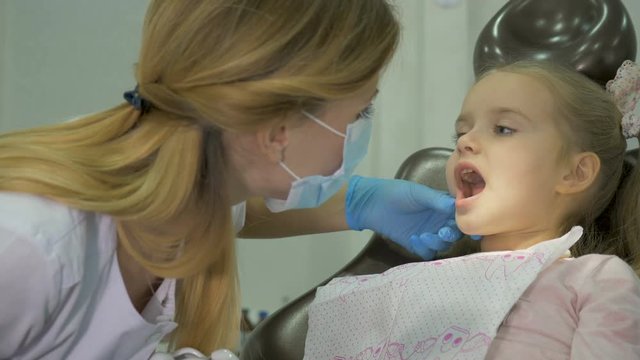 A dentist is treating the teeth to the child.