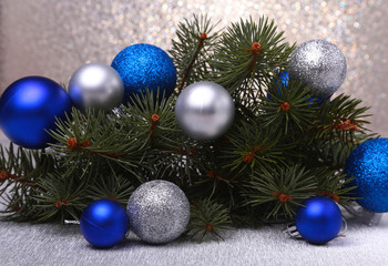 Naklejka na ściany i meble Decorative background with fir branches and balls on the silver. Christmas card Holiday Concept