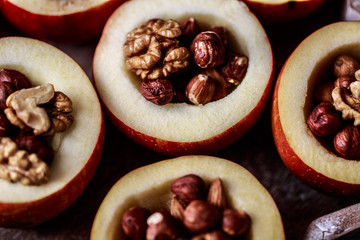 Baked apples with cinnamon on rustic background. Autumn or winter dessert. Closeup photo of a tasty baked apples with christmas decoration