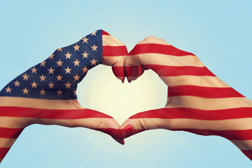 United States of America flag pattern on people hands in heart shaped. United States of America national and patriotism concept © spyrakot