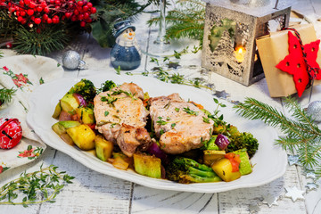 Christmas roasted pork with vegetables. Xmas decorated table