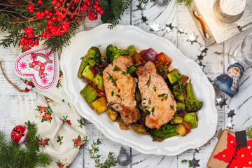 Christmas roasted pork with vegetables. Xmas decorated table