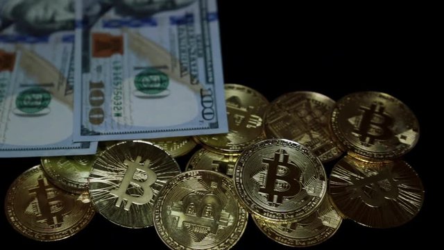 Gold coins bitcoins and American dollars.