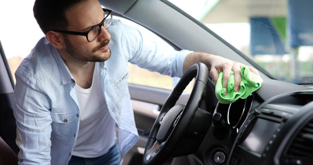 Hand cleaning car steering wheel with microfiber cloth