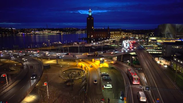 Intense traffic in central Stockholm. In the backdrop the famous City Hall