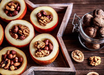 Baked apples with cinnamon on rustic background. Autumn or winter dessert. Closeup photo of a tasty baked apples with christmas decoration