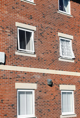 Fototapeta na wymiar Windows on exterior of block of flats