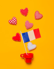 Red cup with heart shapes and flag of France