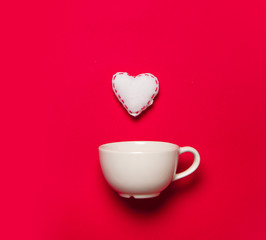 White cup and white heart shape toy