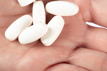 pills in woman hand