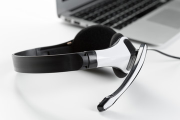 call center support concept. headset on keyboard computer laptop