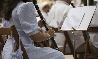 Close up of a young woman playing a clarinet