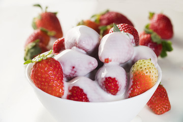 Strawberry with chantilly in white bowl on white background