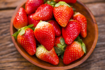 Ripe red strawberries on wooden table