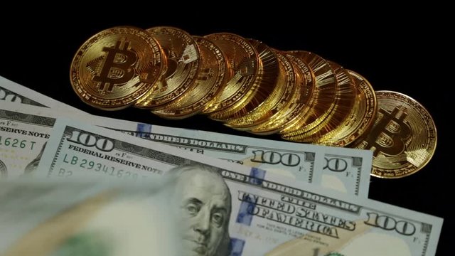 US dollars and bitcoin coins. Crypto currency, bitcoins.