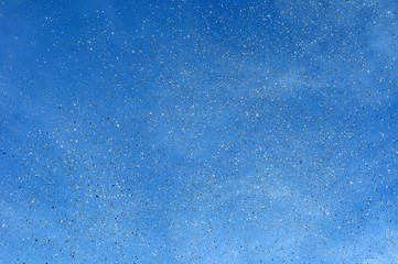 falling golden confetti in the city festival on blue sky background 