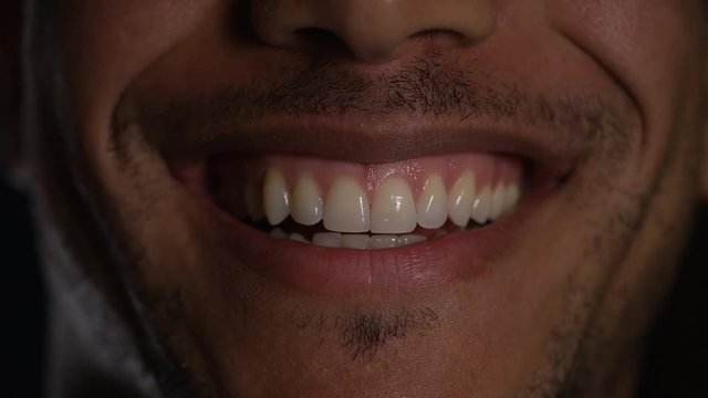 Close up of male mouth smiling and laughing