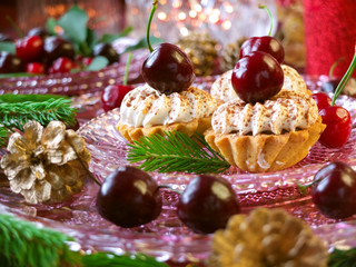 Cupcakes (three cakes) with cherries and whipped cream