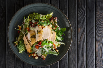 Salad with smoked chicken fillet and bacon chips. Yop view.