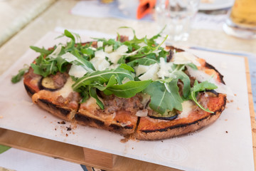 Bruschetta with meat, cheese and rocket
