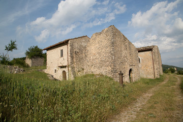 Hiking trail, ancient restored houses in an abandoned mountain village, Central Italy