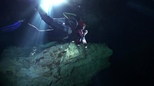 Scuba diving in caves of Yucatan cenotes underwater in Mexico. Natural landscape in clean and clear underground water.