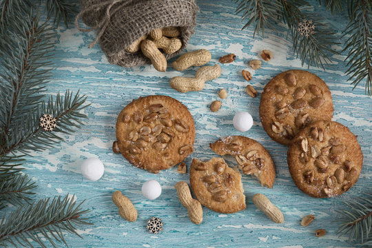 Christmas cookies with peanuts on the table with the Christmas tree.
