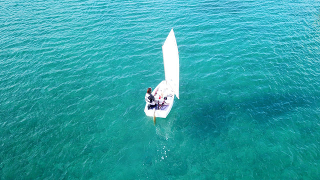 Aerial drone photo of small yachts operated by children in turquoise tropical waters