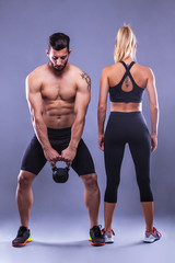 fitness woman and man on a gray background