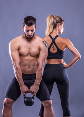 Fototapeta na wymiar fitness woman and man on a gray background