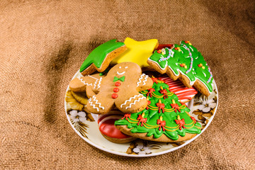 Plate with different christmas gingerbread cookies on a sackcloth