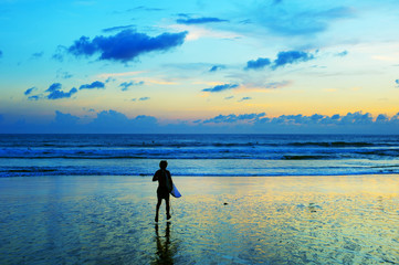 Surfer running in the ocean