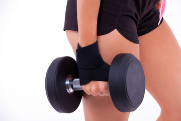 fitness woman with dumbbells on a light background