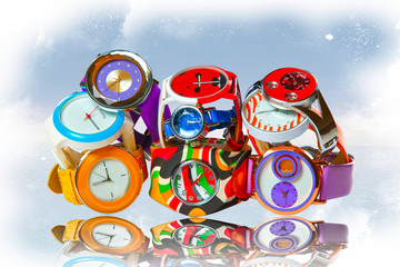 Many multicolored wristwatches folded by a slide
