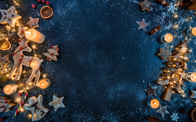 Christmas background with wooden decorations and candles. Free space for text.