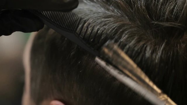 Barber using scissors and comb